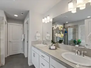 En-Suite off primary bedroom features dual vanities, soaking tub, large shower and walk-in closet.