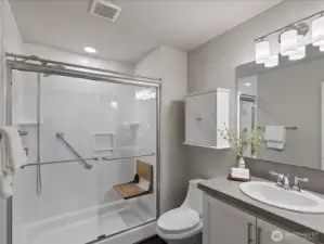 Three-quarter bath in basement with accessible shower.
