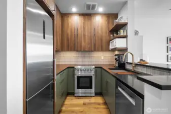 Thoughtful design makes this kitchen live large! Every piece of space has a use! Granite countertops with Yohen/INAX tile backsplash.