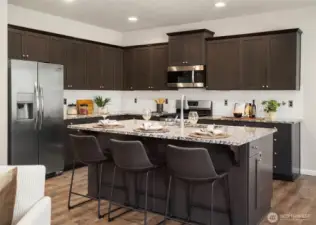 Gorgeous granite countertops and an abundance of cabinets