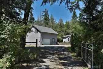 Gated entry for privacy. The oversized two car garage and shop has a +/- 864 sq ft guest apartment with a kitchen, bedroom & full bath.