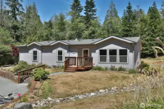 Let's go inside and check out the spacious open floor plan. The three windows to the right of the front door belong to the dining room. The two windows to the left each belong to rooms that could be offices or bedrooms.