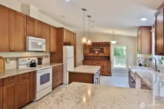 Chef's Kitchen with quartz countertops, maple cabinets and plenty of counterspace.