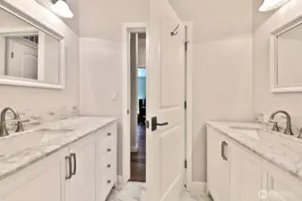 Full bath with two sinks/vanities. This bathroom is located in the hallway next to the 2nd bedroom and two flex rooms.