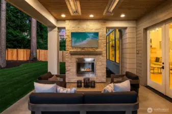 Private outdoor covered living area with fireplace
