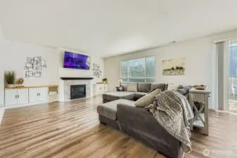 Enormous family room with a cozy gas fireplace and built-ins for a focal point. The open concept design creates a bright and inviting space, perfect for entertaining and relaxing.