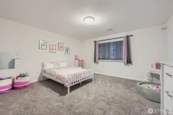 Large bedroom with wall to wall closet space.