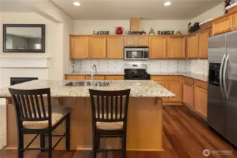 A center island with eating bar and stainless appliances will delight any chef.