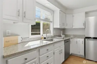 Light and bright kitchen with updated countertops and newer appliances throughout