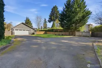 Huge driveway with tons of parking, RV hookups, and a privacy gate that leads to the street.