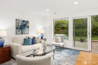 Close up of the living room area. The windows and sliding doors bring the outside in.