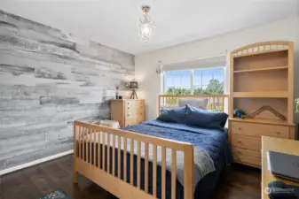 All three additional bedrooms offer flexibility and comfort and this one has a fun statement wall.