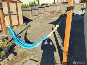 Left side back yard with hammock posts & shed