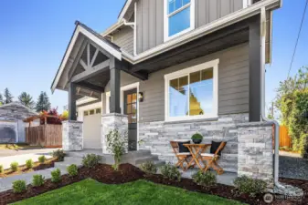Front of home featuring covered seating area.