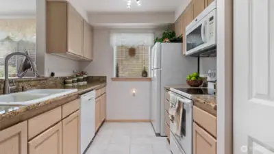 Slab granite countertops enhance the kitchen