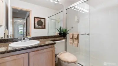 Updated primary bath has easy-entry shower and granite counters