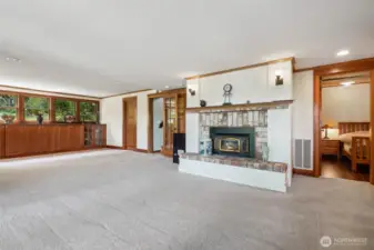 Gas log brick fireplace. the door to the far left is a large finished room presently used for storage.