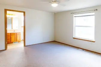 Spacious Primary bedroom with ceiling fan and walk-in-closet.