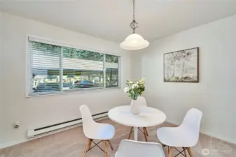 A look at the spacious dining room with updated paint, carpet and light fixture. The unit is in the rear of the complex and all units have double paned windows so the unit is quiet.