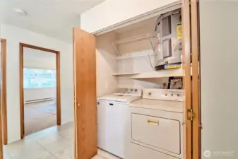 The side by side washer and dryer is conveniently located in an oversized hall closet.