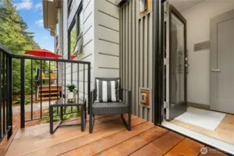 From the laundry area you can step out to your back yard space. Nice room here for a BBQ or extra storage space for gear. There is an access lane for residents that is behind the building. You can pull up and unload your groceries straight into your kitchen.