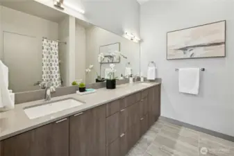 The full bathroom in the second suite has dual sinks, radiant heated floors and a tub shower combo.