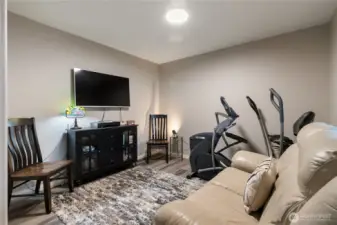 Across from the primary bedroom is the family room with access to the back deck and an outside gathering area.