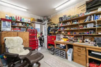 This shop space is heated and has access from the garage and an outside door.