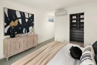 Looking from the primary suite toward the hallway with walk-in closet on the right.  Room would easily hold a king-sized bed.