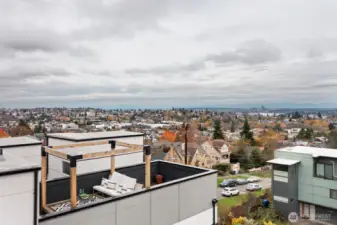 An aerial view of the rooftop deck and seating arrangements. Gazebo is covered in the warm weather months. City of Bellevue in the background to the east.