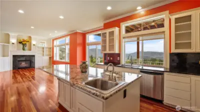 Bright and open kitchen and family room flow to a spacious deck—perfect for entertaining and soaking in breathtaking views.
