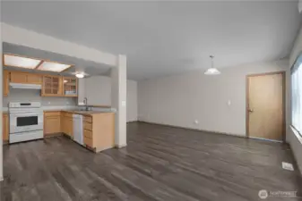 LVP flooring runs through dining, family room and kitchen.