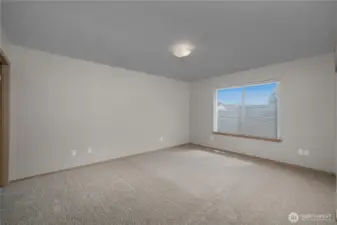 Spacious and well lit primary bedroom.