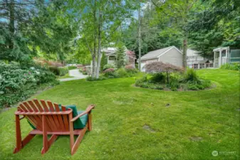 ncredible outdoor spaces with lush landscaping in full bloom, a charming wrap-around porch and patio, and a meandering backyard sanctuary with an enclosed vegetable garden and chicken coop.
