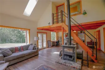 Large open living area with soap stone fireplace w/oven.