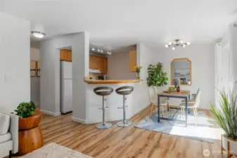 The kitchen features an eating bar that can seat more than two. The dining room, kitchen, and bathrooms have updated lighting.