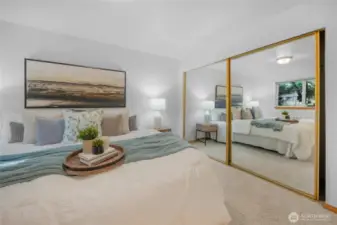 Double mirrored closet doors increase the spacious feel of the primary bedroom.