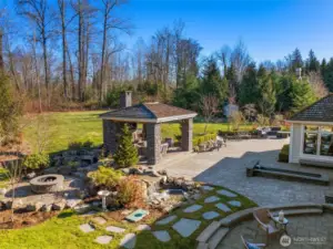 The Expansive Stone Patio Is Designed For Both Style And Comfort, Featuring Multiple Seating Areas Ideal For Gatherings Or Quiet Moments. Two Gas Fireplace Seating Areas....