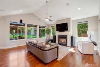 The light filled living room comes with the 4K LG OLED 65" television seen here, and a special mount allows for pulling the tv down for ease of viewing.  This home theater includes 10 speaker Dobly Atmos surround sound.