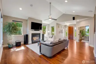 Another view of the living room looking toward the front door.  Notice the vaulted ceilings and the gas fireplace for warmth and atmosphere.  The brazilian walnut hardwood floors are gorgeous!