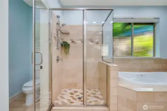 Travertine graces the floors, shower and tub enclosures. A spacious shower and soaking tub - options for every mood.