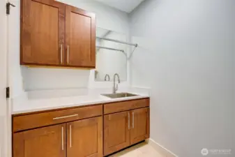 Laundry/utility room.  Quartz countertops and travertine floors.