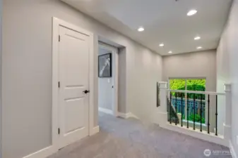 Second floor landing. Bonus room/4th bedroom door at center.  Linen closet left of center.