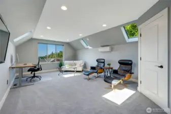 This spacious bonus room with closet could be a 4th bedroom, a large office or a secondary living area. This room enjoys air conditioning and a ductless heat pump.  Four skylights make for a bright and cheerful room, but in the summer, blackout shades can be drawn.  The HD plasma television is included.