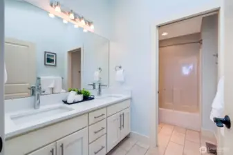 The second floor full bath has amazing natural light from the skylight above.  Travertine floors and quartz countertops.  A separate room for the toilet and shower allow for mulitple people to use the bathroom at once, keeping bathroom squabbles to a minimum.