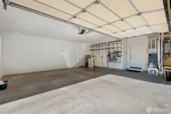This is an extra large, insulated 2-car garage with plenty of room for storage or workspace.  A Tesla wall connector for car charging is included. The house is already plumbed for built in vacuum.