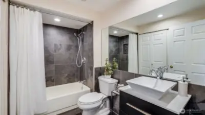 The 2nd bathroom has been updated with new tile, vanity and sink.  The utility room is behind the 2 doors.