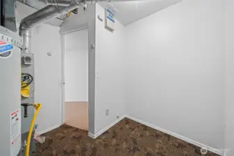 Furnace and water heater area with more additional storage space.