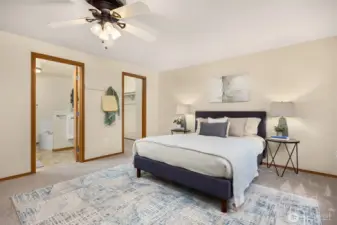Primary bedroom with doors into the walk in closet and the primary bathroom.