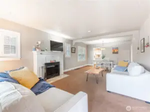 Cozy living room with original wood-burning fireplace and brick surround